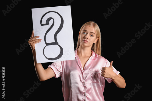 Young woman in pajamas hold...