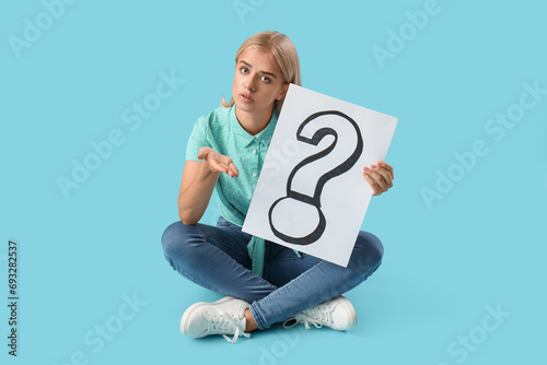 Young woman holding paper w...