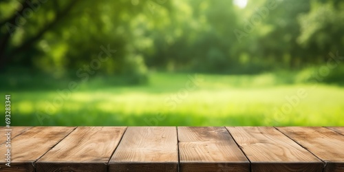 Wooden table on green yard background with empty space for copying © Vusal