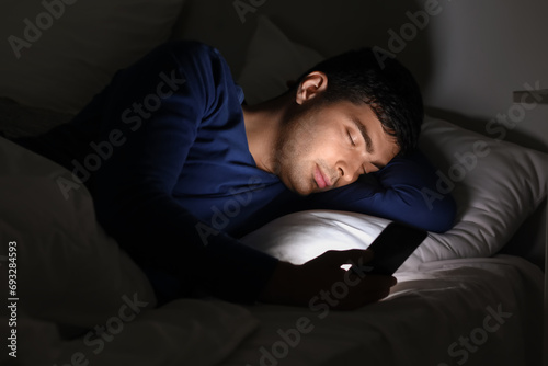 Young man with mobile phone...