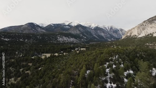 Drone retreating from Mount Antero in the Rocky Mountains in Colorado over pine trees during sunrise photo