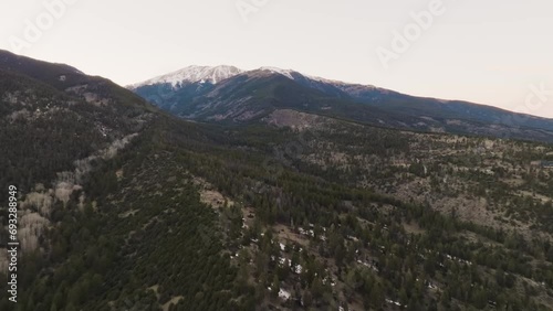 Drone approaching Mount Princeton in the Rocky Mountains in Colorado over pine trees during sunset photo