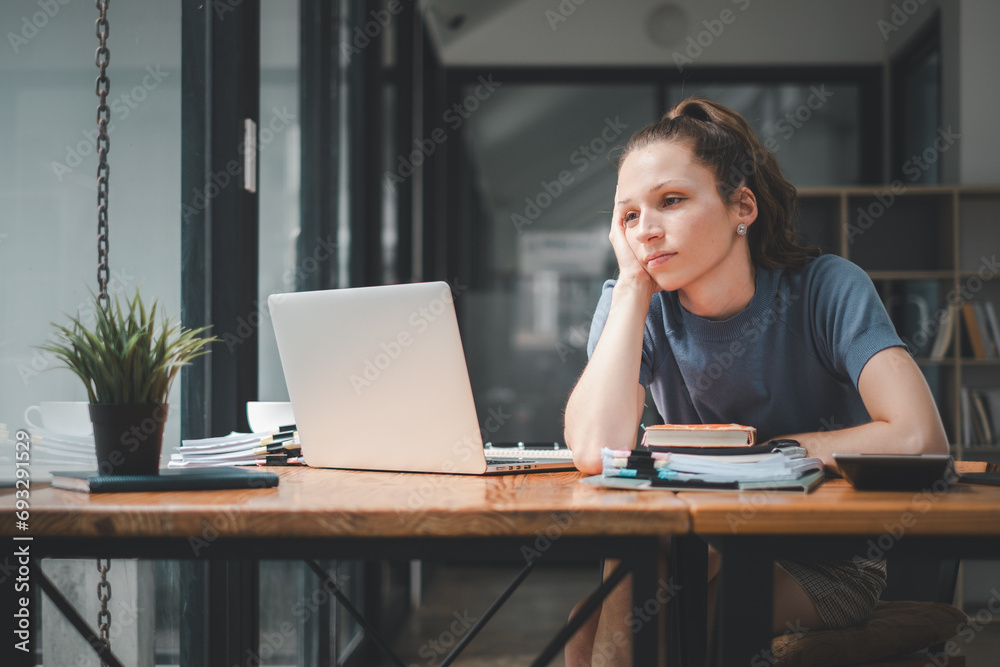 Overworked businesswoman suffering from headache and thinking how to end work. Overworked businesswoman suffering from headache and thinking how to end work.