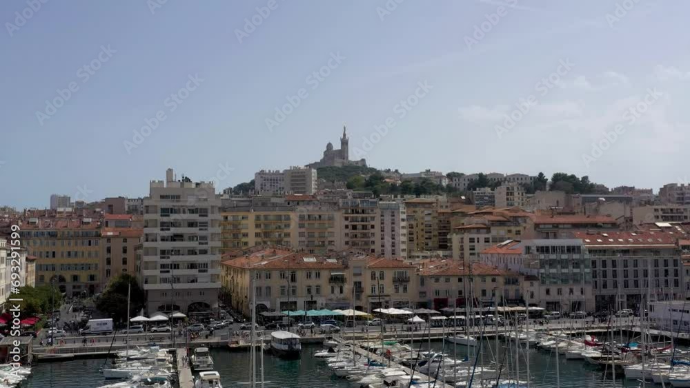 Aerial shot ascending and flying toward Notre-Dame de la Garde situated on a hill overlooking Marseille city. Aerial shot ascending and flying toward Notre-Dame de la Garde situated on a hill overlooking Marseille city.