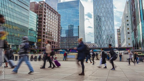 Time lapse of Crowd Commuter business office people walking in rush hour after working at Canary Wharf Station in London, United Kingdom photo