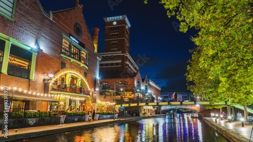 Time lapse of Birmingham cityscape canal side street with crowd people and tourist in Birmingham Brindley Place at nighttime, England, UK photo