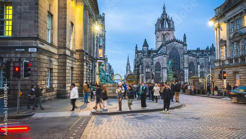 Time lapse of Crowded people tourist walking and traveling around David Hume Statue and St Giles' Cathedral at The Royal Mile High Street in Old town, Edinburgh, Scotland, United Kingdom  photo