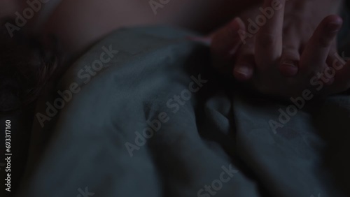 Close up, white woman gripping mans hand in passion while making love in bedroom photo