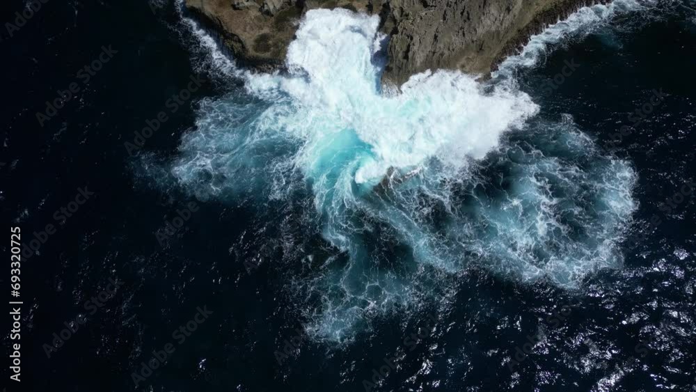 Crashing waves on rocks on the coast of Nusa Penida near Bali, Indonesia. Aerial.