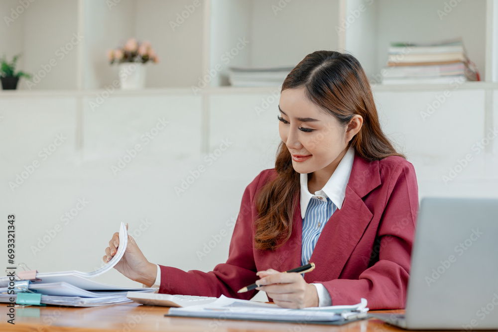 Numerical data is being presented for the accountant to calculate, Female accountant working about financial with calculator at her office, Savings, Finances and economy concept, Numerical data is being presented for the accountant to calculate, Female accountant working about financial with calculator at her office, Savings, Finances and economy concept,