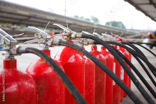 Red tank of fire extinguisher Overview of a powerful industrial fire extinguishing system. ready for use in case of an outdoor fire emergency. photo