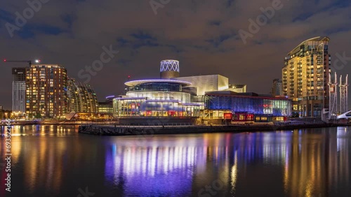 Day to night Time lapse Long exposure of the Media city Salford quays, riverbank building in Manchester photo