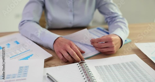 Closeup of woman in hands and leafing through document