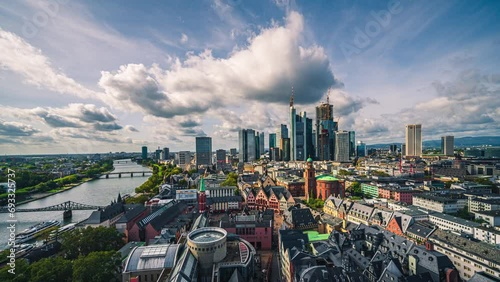 Time lapse of Cloud sky with blue sky over Frankfurt am Main skyline beside Main river and modern finance building and skyscrapers, Germany photo