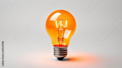 an orange light bulb, highlighting its vibrant illumination and lively hue, perfectly isolated against a clean white backdrop.