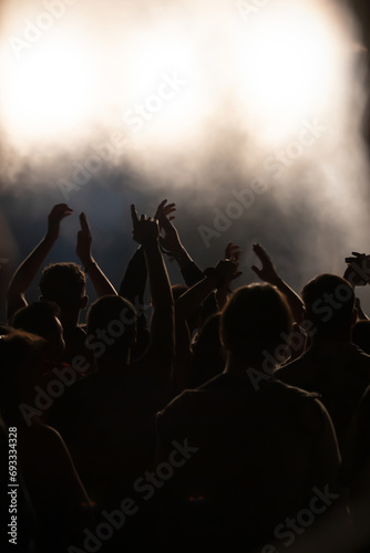 Abstract photo of crowd at concert and blurred stage lights.