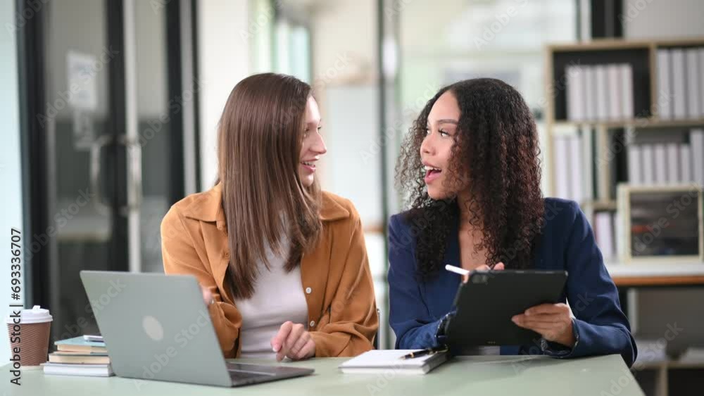 Two business workers talking on the smartphone, tablet and using laptop at office. Two business workers talking on the smartphone, tablet and using laptop at office.