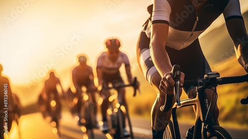 Close-up of a group of cyclists with professional racing sports gear riding on an open road cycling route