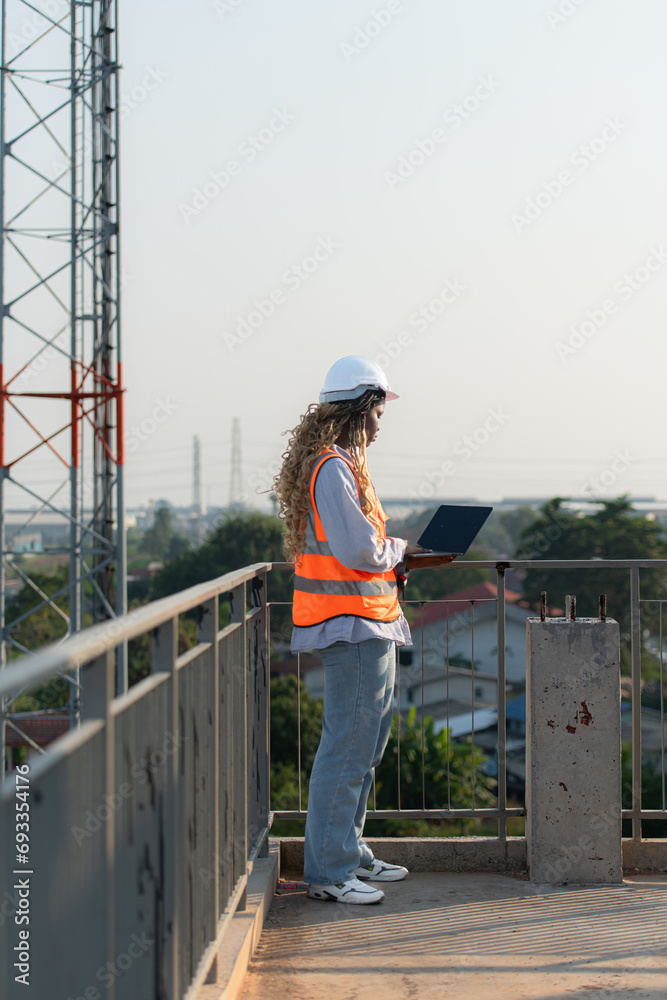 Engineer working on a building site The telephone and internet network signal systems of the construction building are being inspected. Engineer working on a building site The telephone and internet network signal systems of the construction building are being inspected.