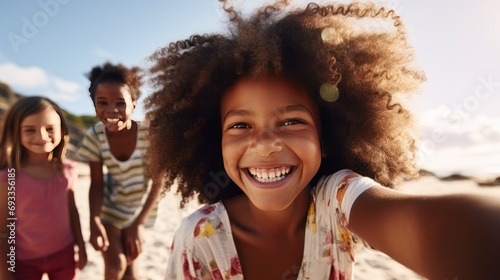 Young African American woman smiling with children Taking a selfie at the beach with her best friend.