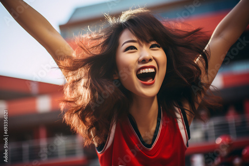 Enthusiastic asian woman in red, surrounded by fans, cheering for victory in a sports competition. Diverse team spirit. Generative ai image photo