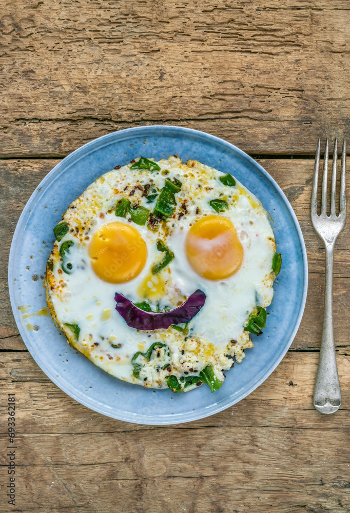 sunny side up fried egg with smiling face shape on plate sunny side up fried egg with smiling face shape on plate