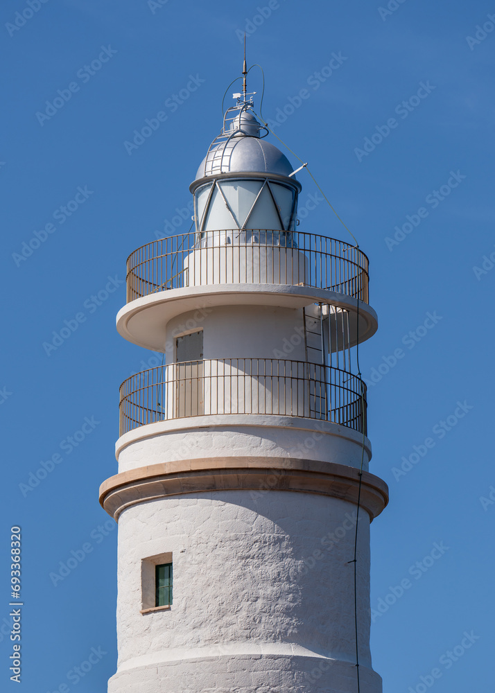 White lighthouse against a blue sky close-up. Port de Soller, Mallorca, Spain White lighthouse against a blue sky close-up. Port de Soller, Mallorca, Spain