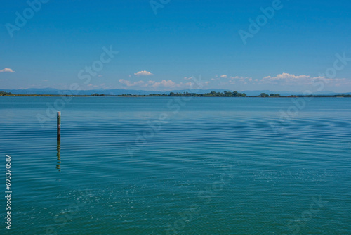 A channel marker shows the edge of a navigable channel in the shallow waters in the Grado section of the Marano and Grado Lagoon in Friuli-Venezia Giulia, north east Italy. August