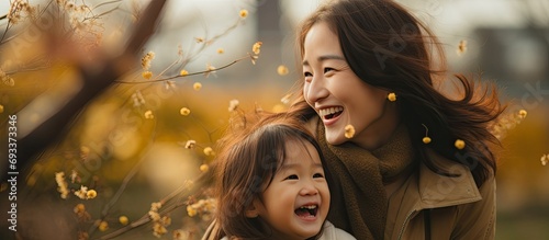 Mother and daughter have joyful times in the park during the holiday season.