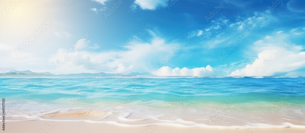 Summer beach blur defocused background. tropical with golden sand, turquoise ocean blue sky with white clouds on bright sunny landscape for holidays product presentation.
