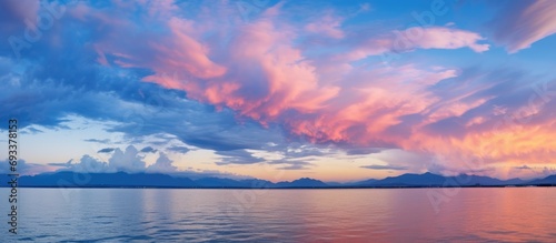 Picturesque spectacular colorful sky at sunset or dawn with dark blue clouds and pink lighting.