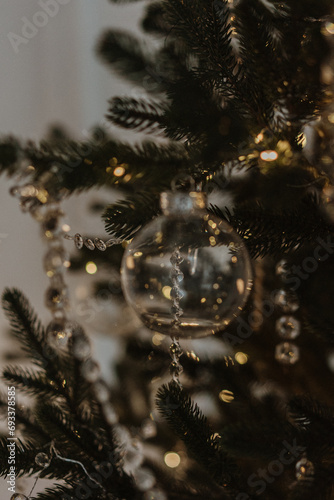 beautiful new year's toys, festive mood, selective focus, against the backdrop of bokeh from the lights of the garland. glass Christmas toys and glass icicles