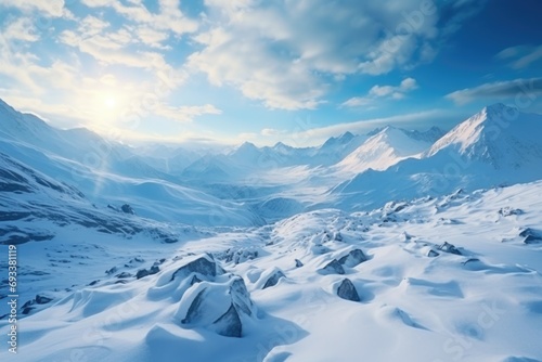 A stunning snow-covered mountain range with a bright sun shining in the sky. Perfect for nature and landscape enthusiasts