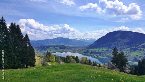 Malerische Landschaft am Großen Alpsee mit Bergen, Wiesen, Wäldern und einem imposanten Wolkenhimmel. Immenstadt im Allgäu, Oberallgäu, Schwaben, Bayern, Deutschland. photo