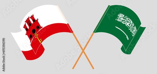 Crossed and waving flags of Gibraltar and Saudi Arabia