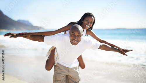 Black couple, smiling and piggyback with portrait, beach and married for summer vacation. African, enjoying and happy for holiday, fun and seaside in outdoor, beautiful and day off in costal city