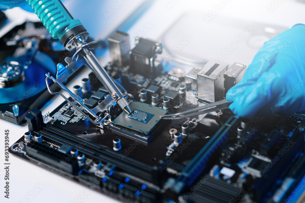 The technician is putting the CPU on the socket of the computer motherboard. electronic engineering electronic repair, electronics measuring and testing, repair.. - obrazy, fototapety, plakaty 