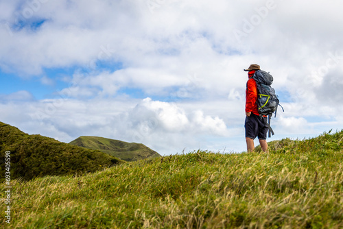 Hiker with a Backpack Standing on a Hill on São Jorge Island in the Azores