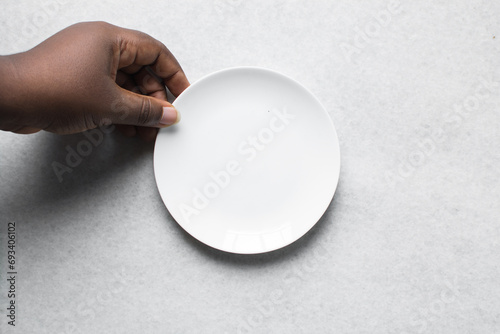 Top view of a large white ceramic plate, a round white ceramic dinner plate on a marble surface