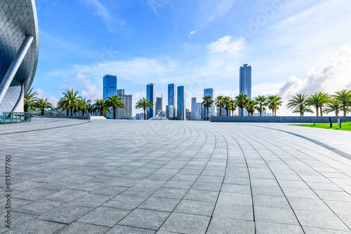 Fototapeta Naklejka Na Ścianę i Meble -  Empty square floors and city skyline with modern buildings under blue sky