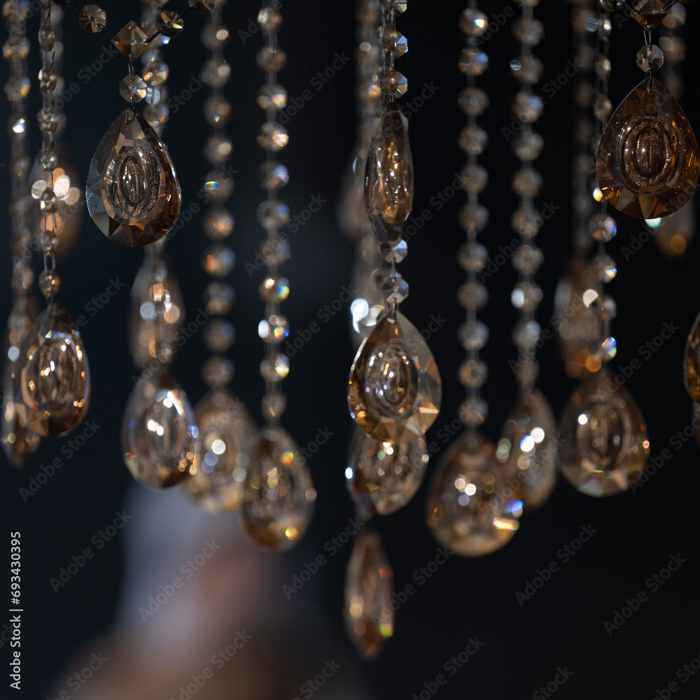 Crystal on a chandelier close-up on a dark background. Crystal on a chandelier close-up on a dark background.