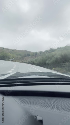 First person view, FPV, from dashcam of car driving in the Sierra Nevada mountains, Granada, Andalusia, Spain, Europe. Road trip vertical video in POV from inside vehicle photo