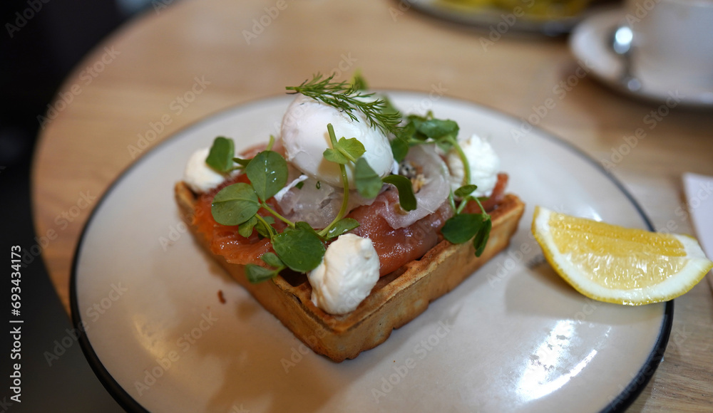 Smoked salmon cream cheese with rocket toast serving on white plate