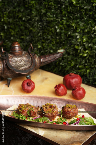 Shashlik or shish kebab with herbs, onion and pomegranate