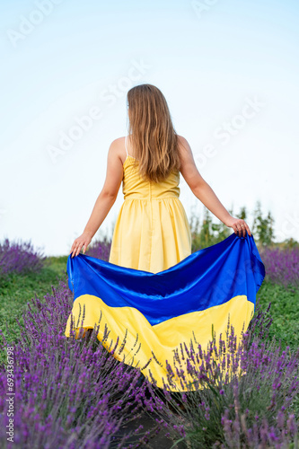 Ukrainian flag in the hands of a girl.