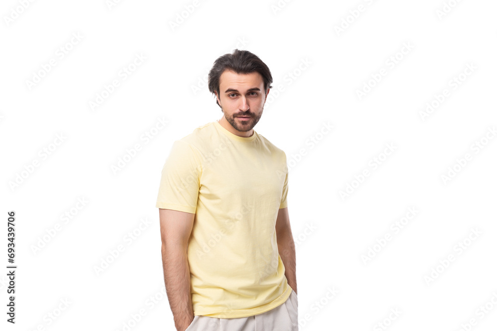 young brutal brunette man in a T-shirt on a white background with copy space young brutal brunette man in a T-shirt on a white background with copy space