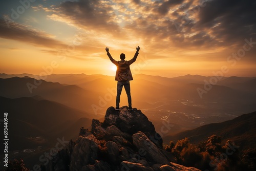 a person standing on a mountain with their arms raised