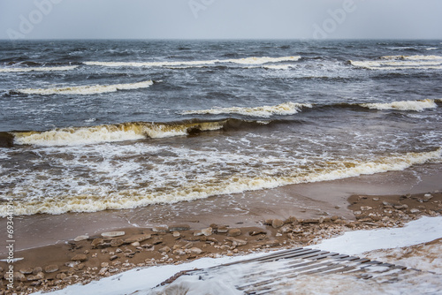 Baltic Sea snowy beach, big waves in the sea on winter photo