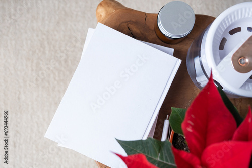 blank books with pen and poinsettia plant photo