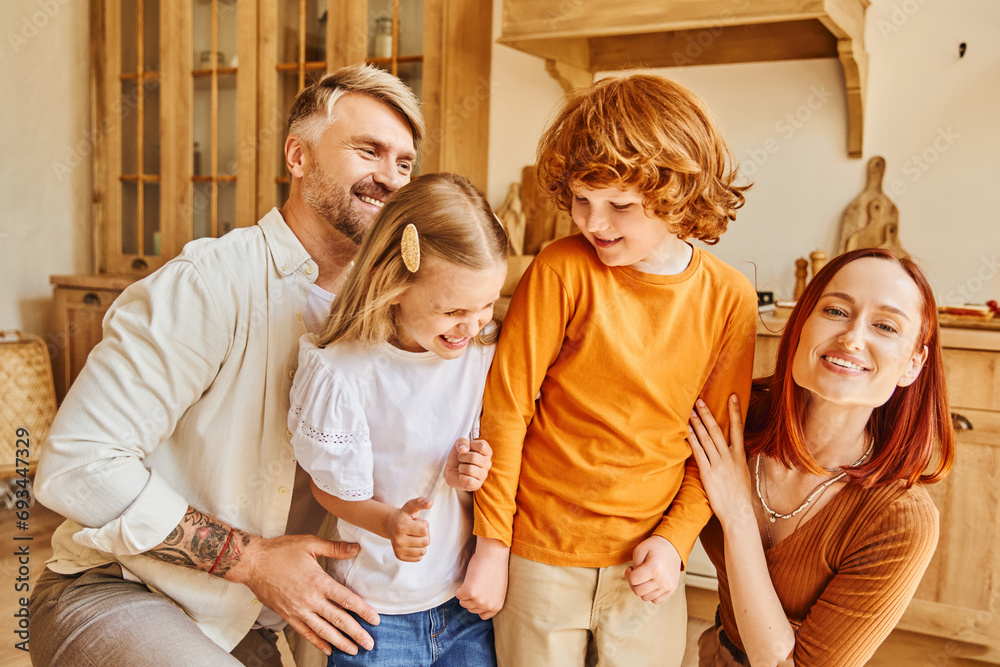 joyful parents embracing excited daughter and son in cozy kitchen at home, unconditional love joyful parents embracing excited daughter and son in cozy kitchen at home, unconditional love